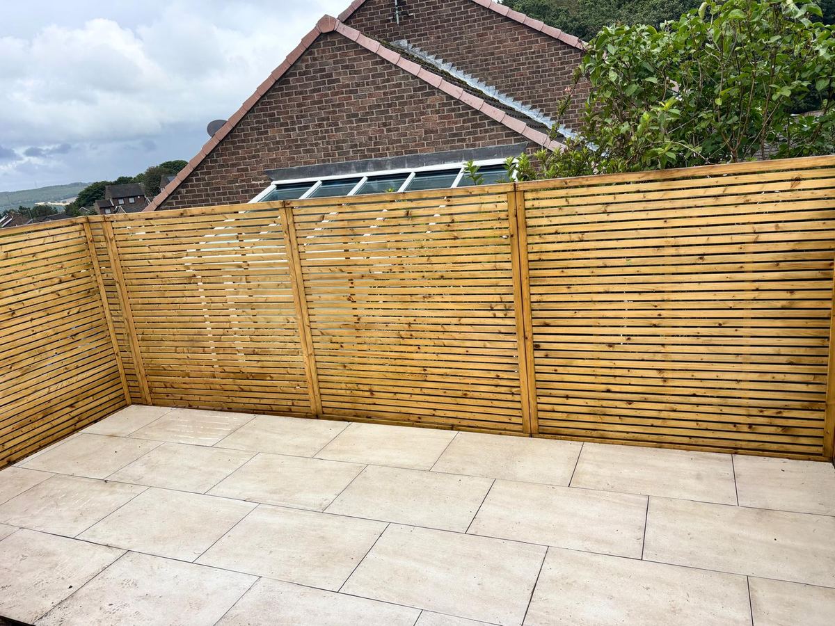After: finished slatted fencing around a new porcelain patio