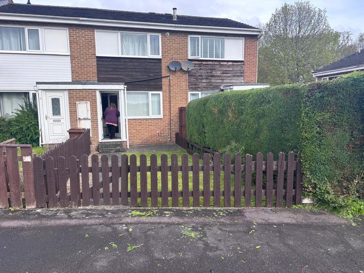 Front hedge cut back behind a picket fence